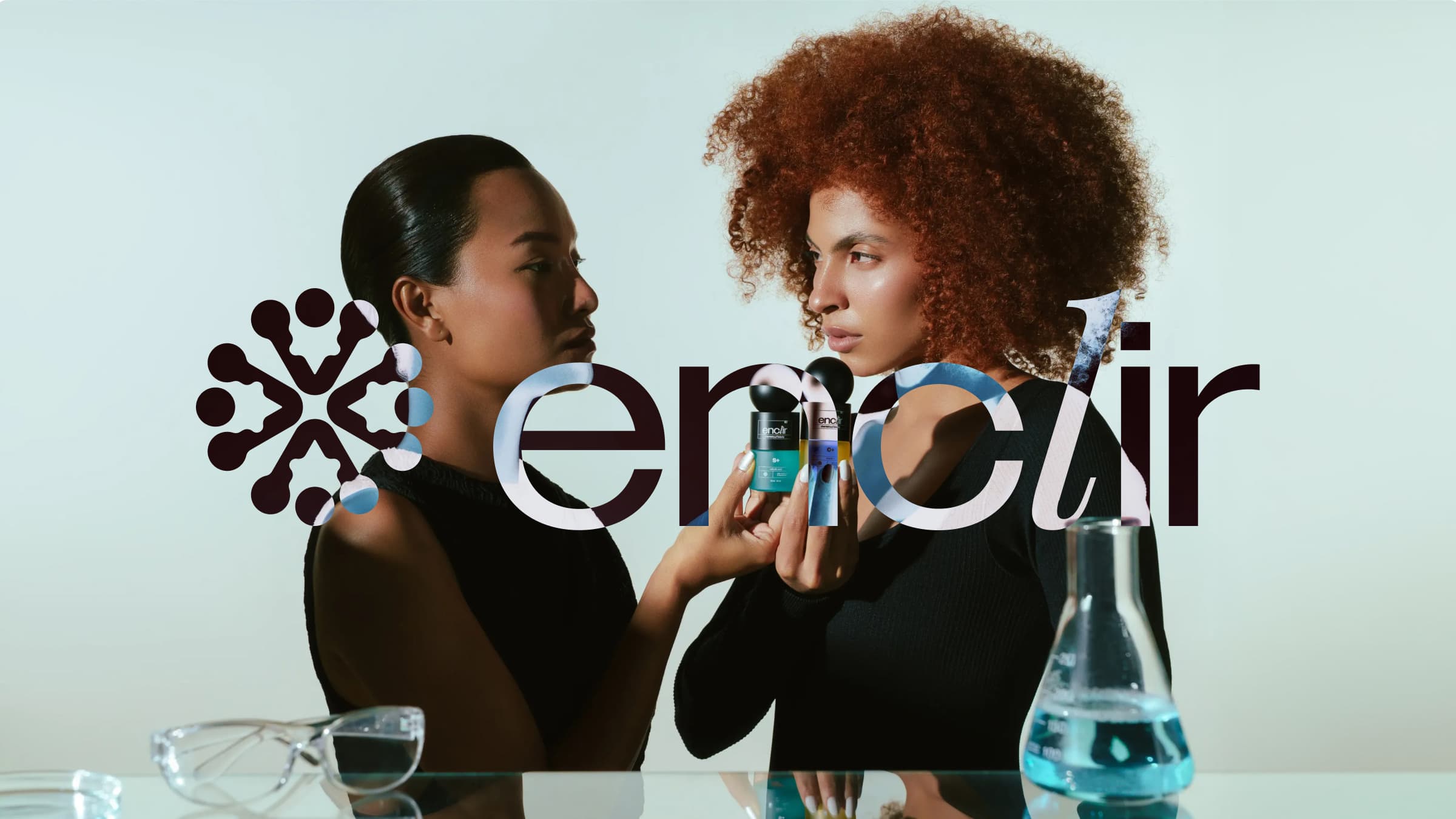 Enclir campaign image of two models holding the S+ and C+ serums in a lab setting, with the Enclir logo overlaid
